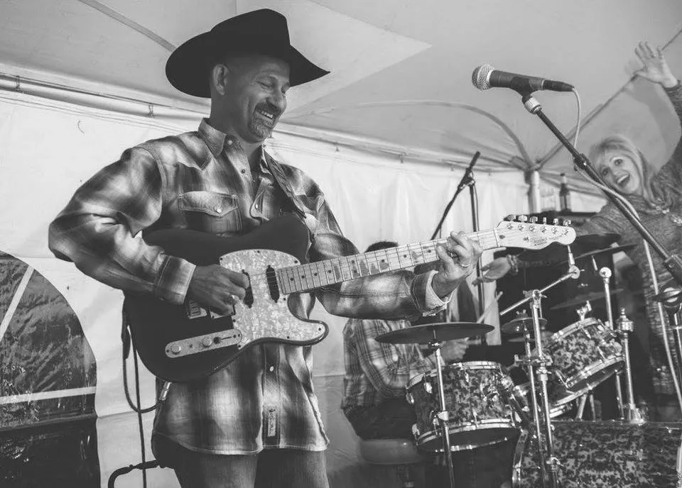 Clay Potter — Lead Vocals & Guitar Clay Potter playing electric guitar and singing on stage with the Clay Potter Band