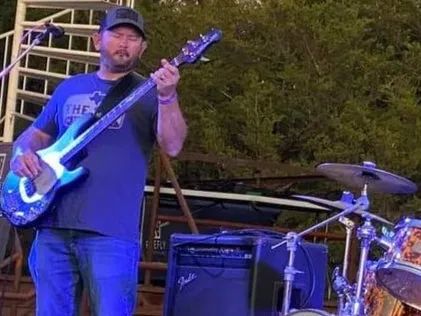 Kevin Eaker — Bass Guitar & Background Vocals Kevin Eaker playing bass guitar during a Clay Potter Band performance