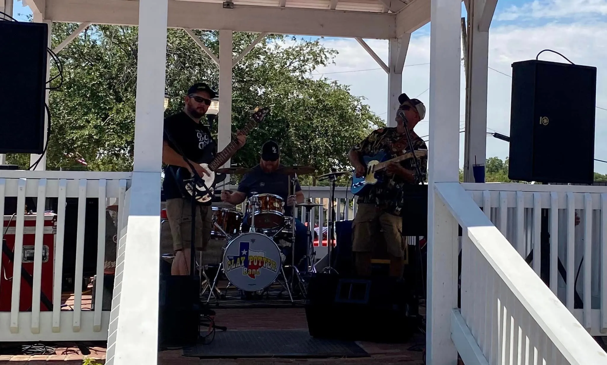 The Clay Potter Band playing a daytime show from a covered gazebo stage The Clay Potter Band playing a daytime show from a covered gazebo stage