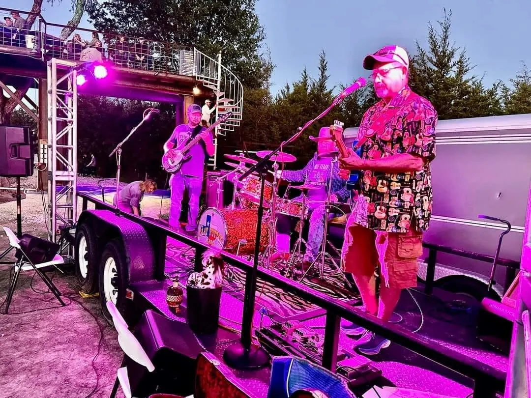 Clay Potter Band on stage bathed in pink and purple concert lighting Clay Potter Band on stage bathed in pink and purple concert lighting