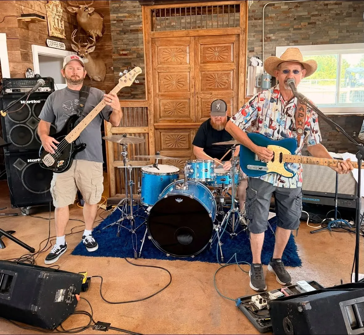 Clay Potter Band on bass, drums, and lead guitar playing inside a rustic Texas ranch hall Clay Potter Band on bass, drums, and lead guitar playing inside a rustic Texas ranch hall